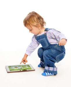 Young toddler touching tablet pc